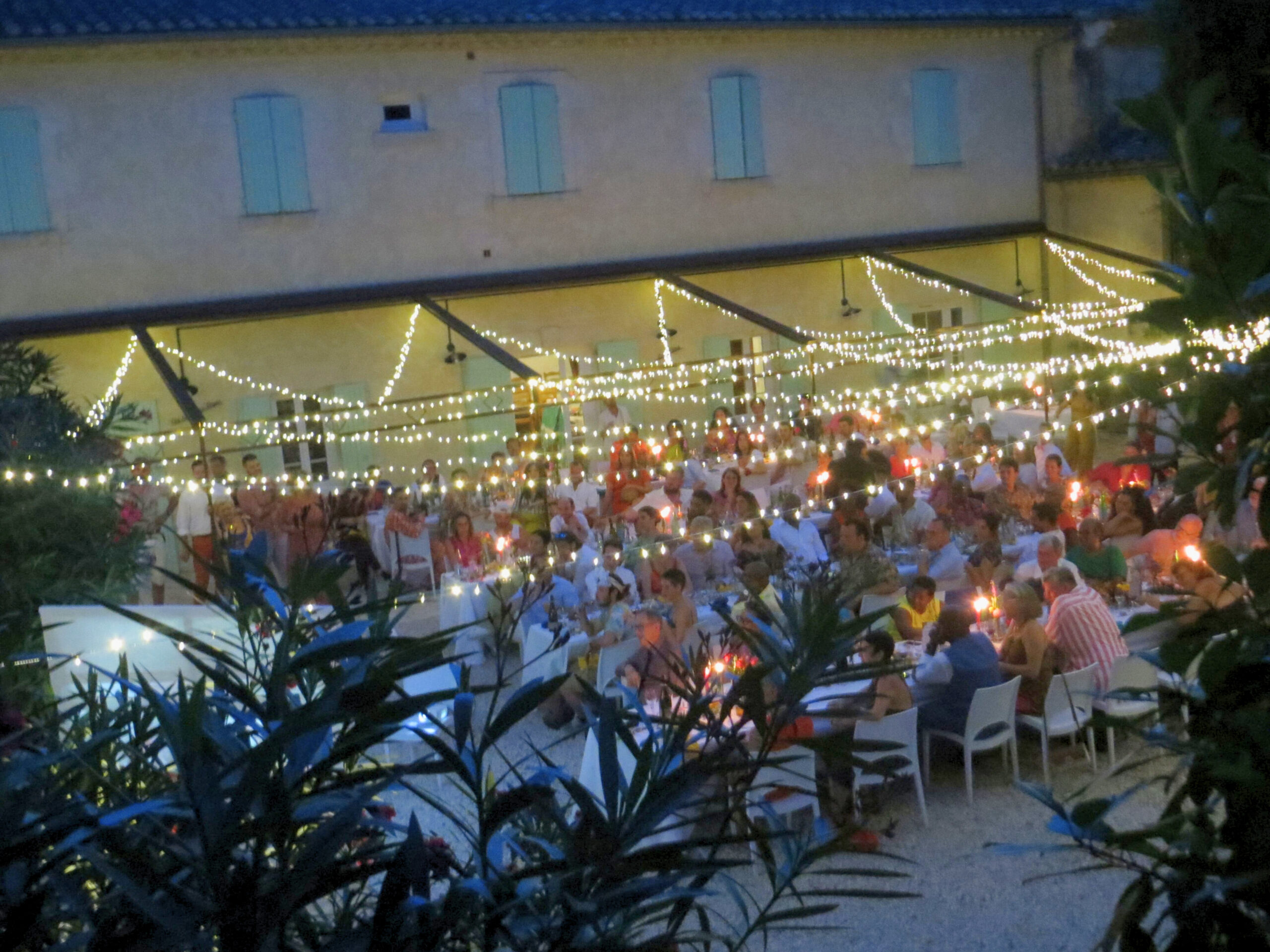 Guests at a wedding dinner in an outdoor area by night