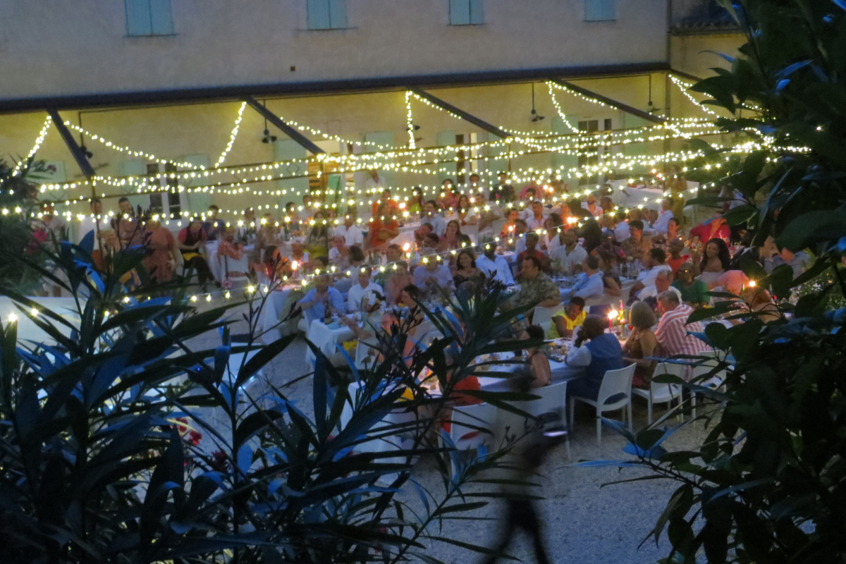 Guests at a wedding dinner in an outdoor area by night